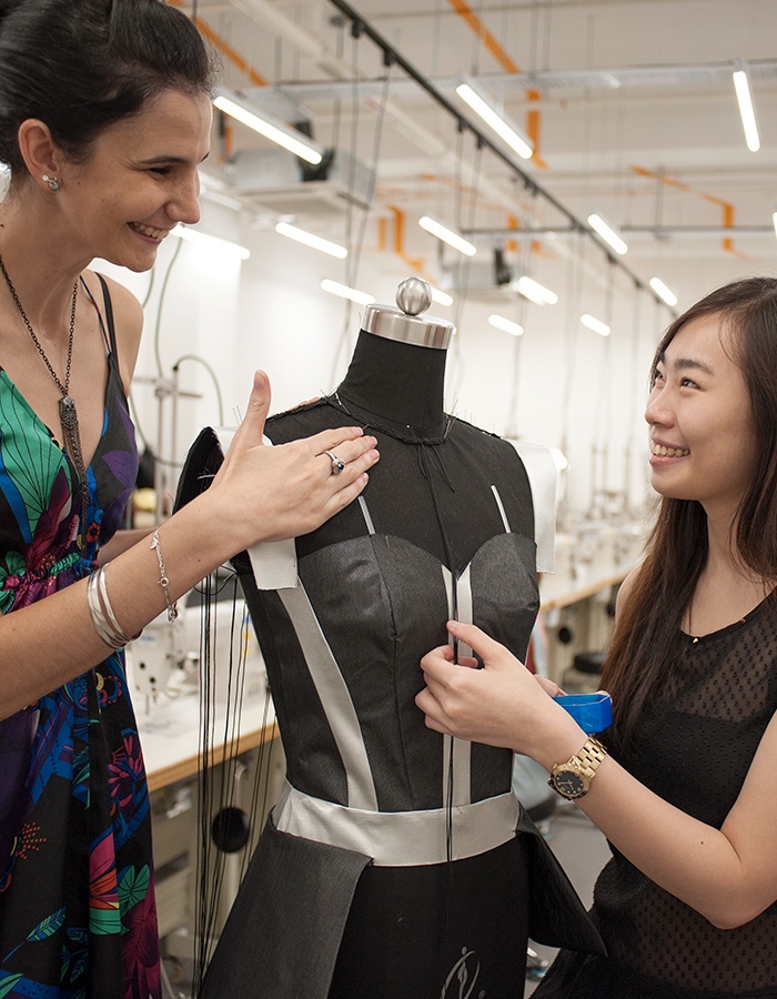 creative practioner student draping on black mannequin